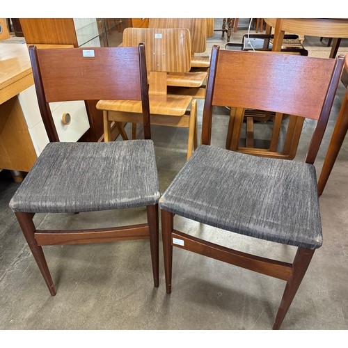 241 - A pair of teak dining chairs