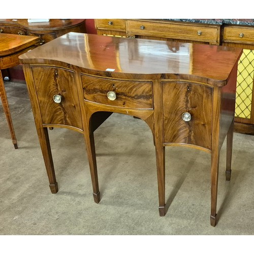 144 - A George III mahogany serpentine sideboard