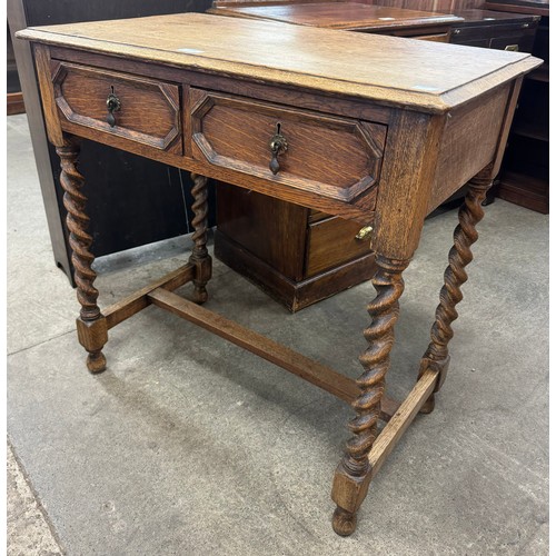 256 - A 17th Century style oak barleytwist two drawer side table