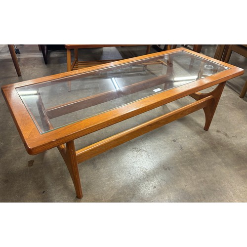 221 - A Stonehill Stateroom teak and glass topped coffee table