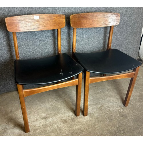 234 - A pair of teak and black vinyl dining chairs