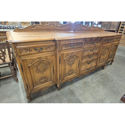 272 - An 18th Century style French carved oak breakfront sideboard