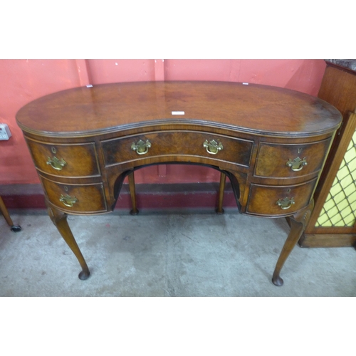 149 - A Queen Anne style walnut kidney shaped desk