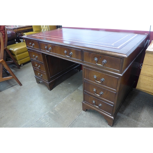 151 - A George III style mahogany red leather topped pedestal desk