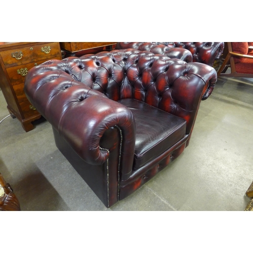 154 - An oxblood red leather Chesterfield club chair