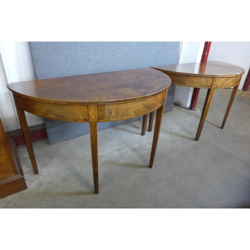 169 - A pair of George III inlaid mahogany demi lune console tables