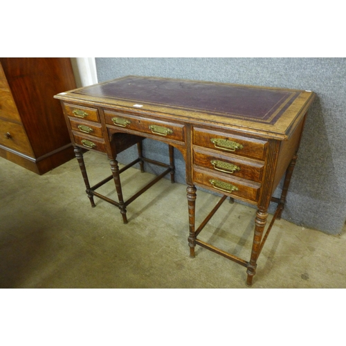 181 - A Victorian Aesthetic Movement oak and red leather topped desk