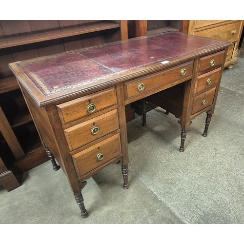 180 - A Victorian mahogany and red leather topped pedestal desk