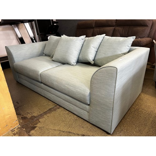 1532 - A sky blue upholstered three seater sofa