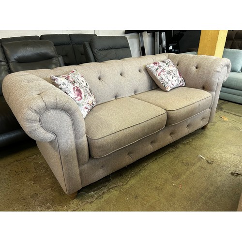 1538 - A beige weave Chesterfield three seater sofa