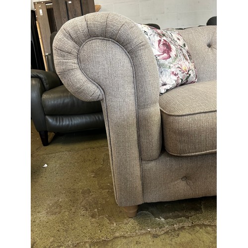 1538 - A beige weave Chesterfield three seater sofa