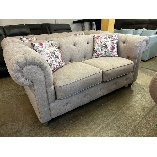 1539 - A beige weave Chesterfield two seater sofa