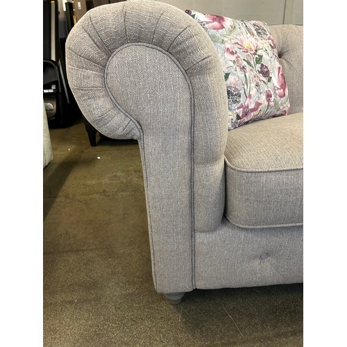 1539 - A beige weave Chesterfield two seater sofa