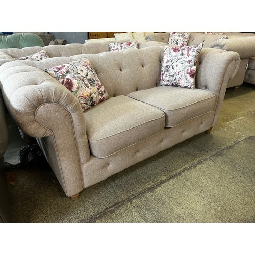 1541 - A beige weave Chesterfield two seater sofa