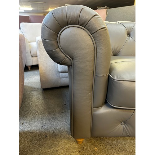 1545 - A dark grey leather Chesterfield two seater sofa