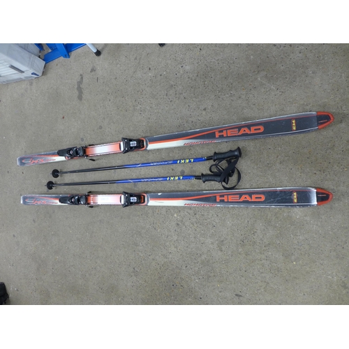 2174 - A set of Head M3 Monotop skis and a pair of Leki Spyder ski poles in a Fischer carry bag