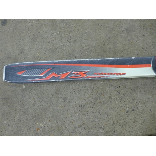 2174 - A set of Head M3 Monotop skis and a pair of Leki Spyder ski poles in a Fischer carry bag