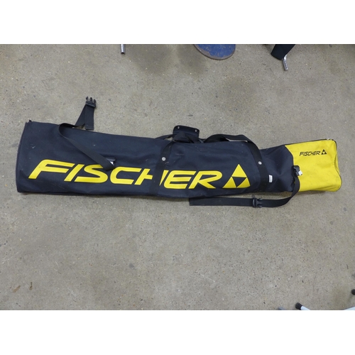 2174 - A set of Head M3 Monotop skis and a pair of Leki Spyder ski poles in a Fischer carry bag