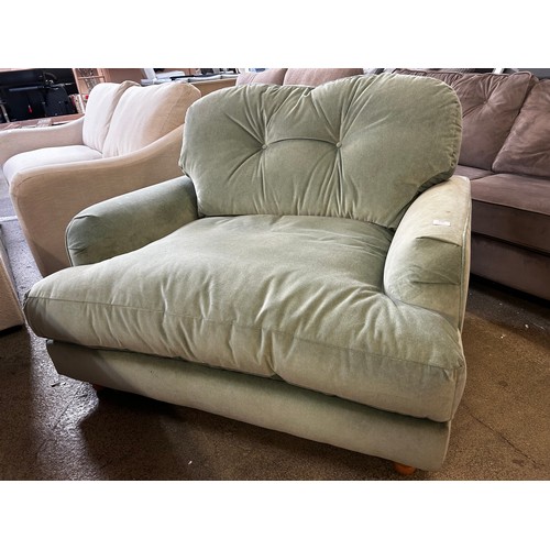 1375 - A sage velvet upholstered snuggle sofa RRP £699