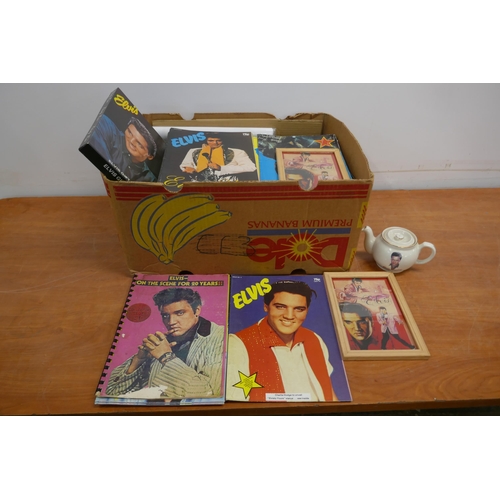 2050 - A crate of Elvis Presley memorabilia including a teapot, black and white prints, wash set, cups, pla... 