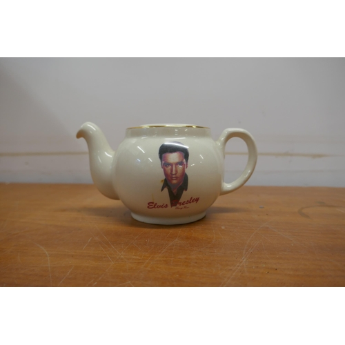 2050 - A crate of Elvis Presley memorabilia including a teapot, black and white prints, wash set, cups, pla... 