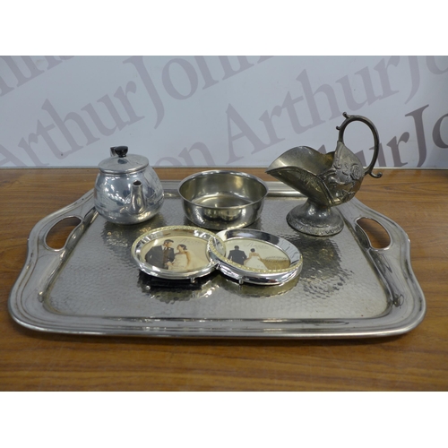 2217 - A crate of mixed silver coloured and silver plated items including photo frames, teapot, candle hold... 