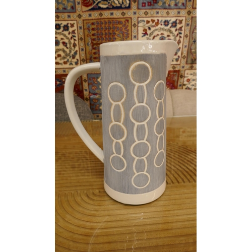 1329 - A large grey ceramic Emilie jug with circle print decoration  H26cms (7HM22312)   *