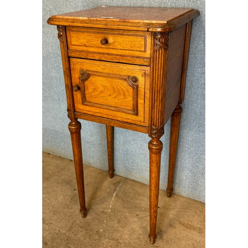 158 - A French oak and marble topped table de nuit