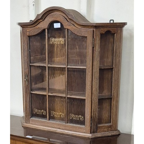 337 - An oak wall hanging shop display cabinet, bearing Fry's inscription