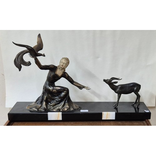 336 - A French Art Deco painted spelter figure of a lady and antelope, on slate base