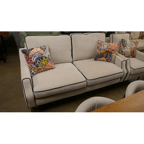 1343 - A light stone three seater sofa and armchair with contrasting piping and scatter cushions RRP £1948