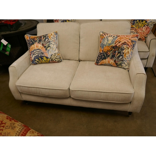 1381 - A two and a half seater with contrasting piping and scatter cushions RRP £1179 - repaired leg