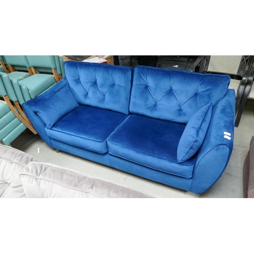 1564 - A blue velvet Hoxton three seater sofa - damaged