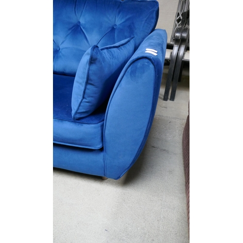 1564 - A blue velvet Hoxton three seater sofa - damaged