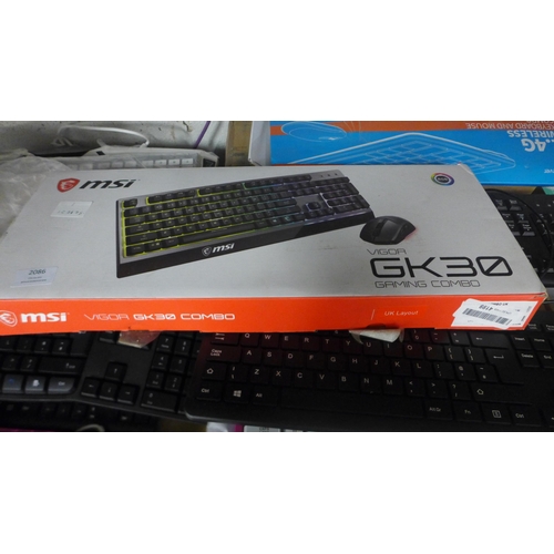 2086 - A quantity of various wireless and wired keyboards including MSI, KROM Barbie themed keyboard, Logit... 