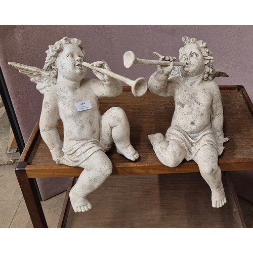 354 - A pair of 18th Century style French white faux plaster cherubs