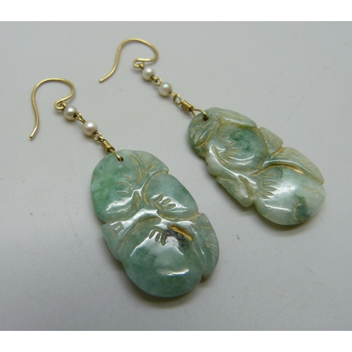 1033 - A pair of carved jade and pearl earrings on hallmarked 18ct gold wires, jade 18mm x 30mm