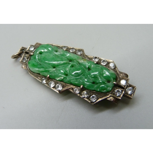 1035 - A jade and white stone set clip converted into a pendant, a coral set pendant and two other pendants