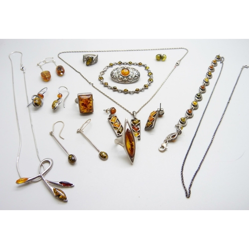 1050 - A collection of silver and amber jewellery including three rings