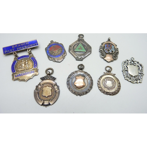 1059 - Six silver fob medals, two with applied gold, one other fob medal and a silver and enamelled badge, ... 