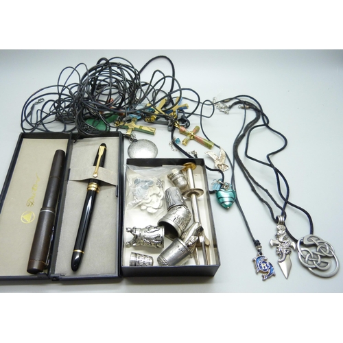 1064 - Two pens, one with 14ct nib, an olive pick, thimbles, stone set cross pendants, etc.