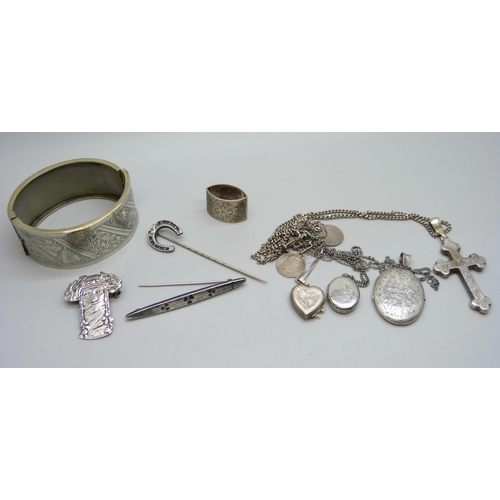 1098 - A hallmarked silver shamrock brooch, a bangle, three lockets, a cross pendant, etc.