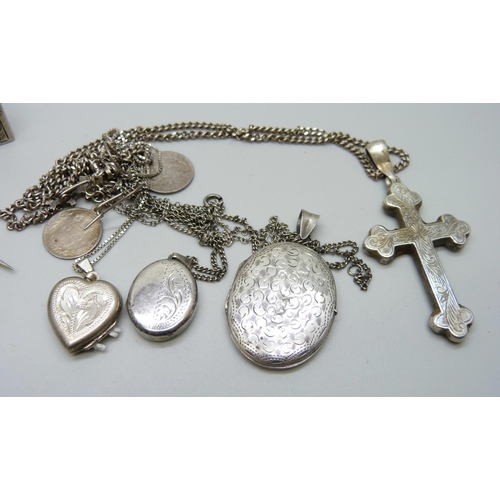 1098 - A hallmarked silver shamrock brooch, a bangle, three lockets, a cross pendant, etc.