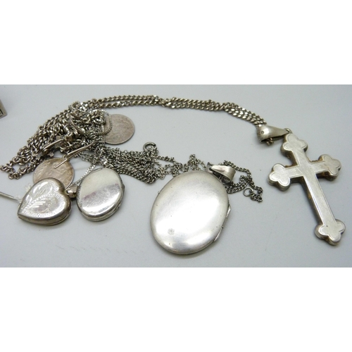 1098 - A hallmarked silver shamrock brooch, a bangle, three lockets, a cross pendant, etc.