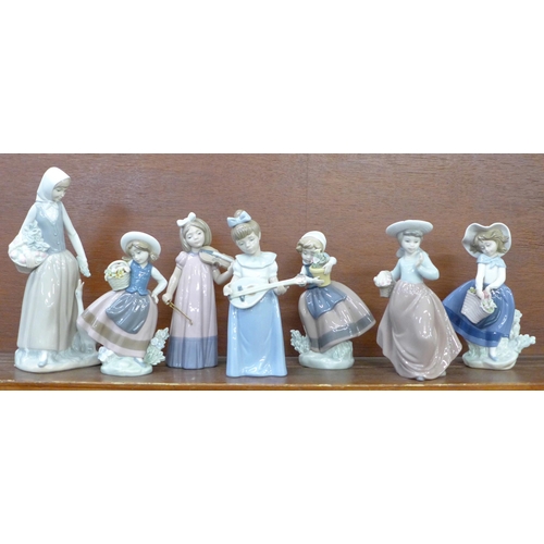 609 - Three Lladro figures and four Nao figures, two a/f