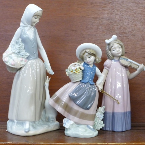 609 - Three Lladro figures and four Nao figures, two a/f