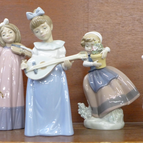 609 - Three Lladro figures and four Nao figures, two a/f