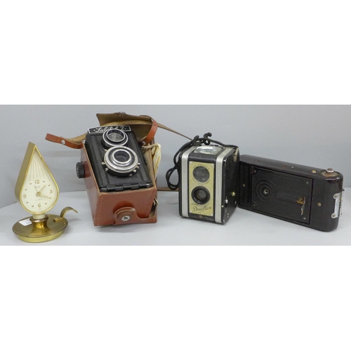 616 - A Swiss 1950s Swiza alarm clock, three cameras including Lubitel 2