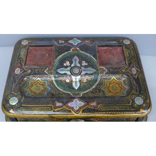 637 - A paper mache pen stand with a pair of ink bottles, painted and inlaid with mother of pearl, 27cm