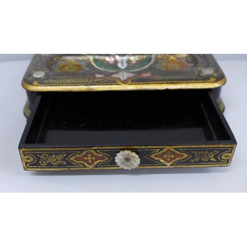 637 - A paper mache pen stand with a pair of ink bottles, painted and inlaid with mother of pearl, 27cm